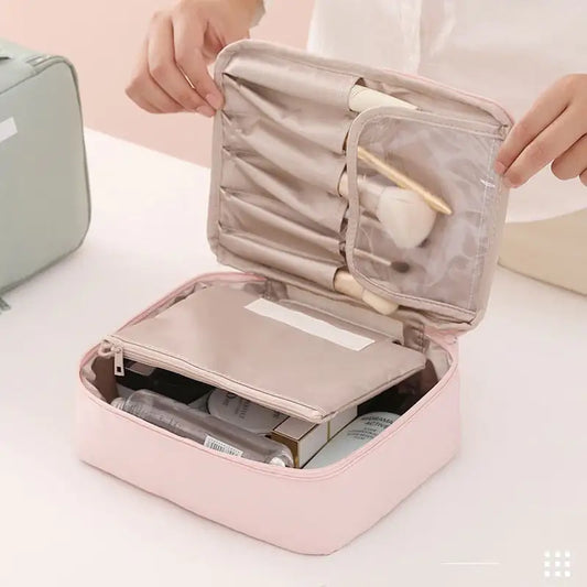 Pink makeup organizer with cosmetic items on a white surface