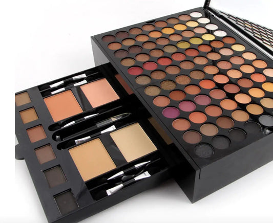 Makeup palette with various shades of eyeshadows and brushes on a white background