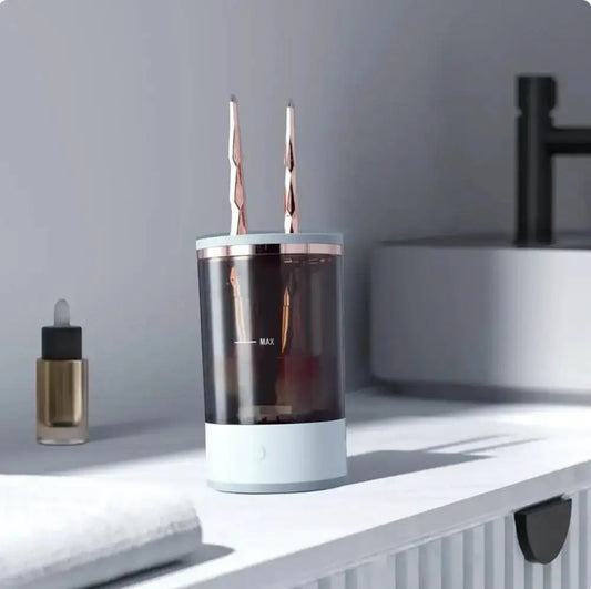 Clear cylindrical container with two metallic objects on a white surface
