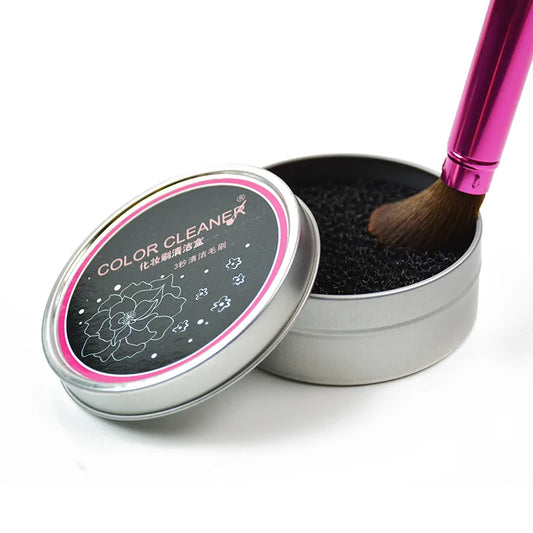 Color cleaner with a brush inside a metal tin on a white background