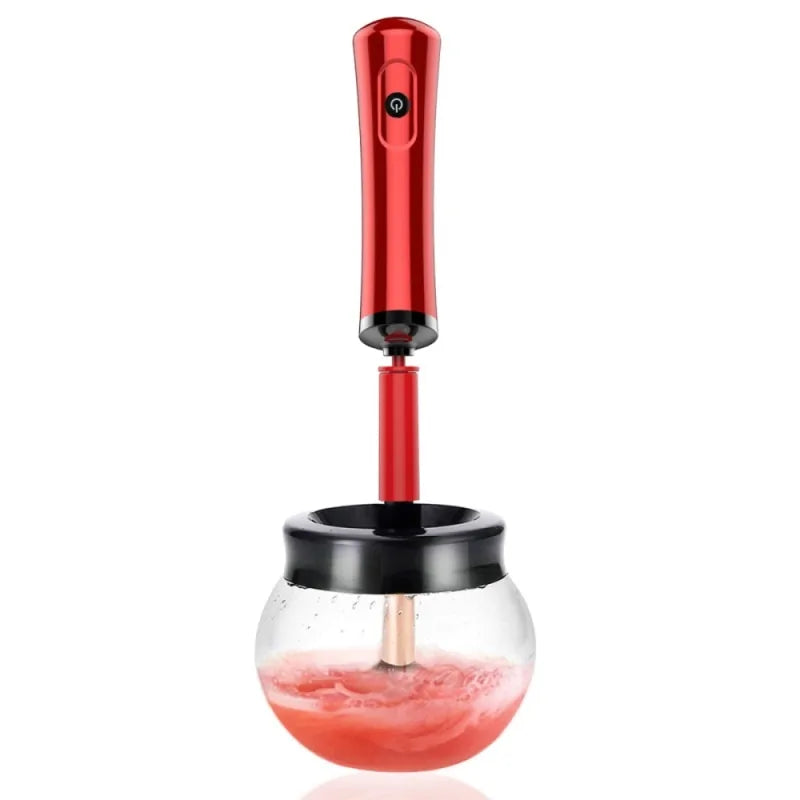 Red handheld juicer with a clear container on a white background