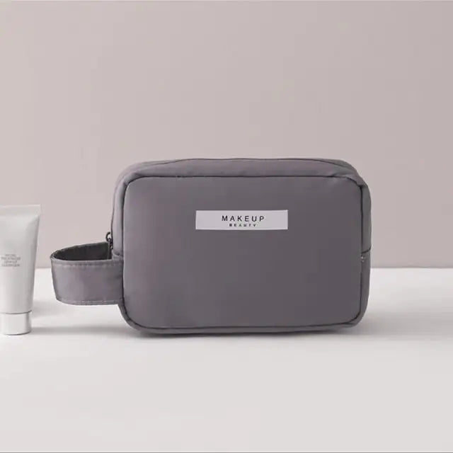 Gray makeup bag with 'MAKEUP REVOLUTION' label on a light background