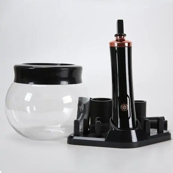 Black and clear glass container with a stand on a white background