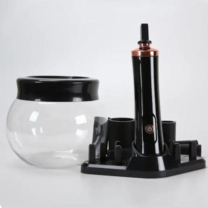 Black and clear glass container with a stand on a white background