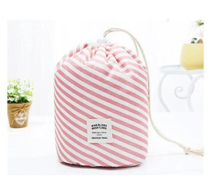 Pink and white striped drawstring bag on a white background