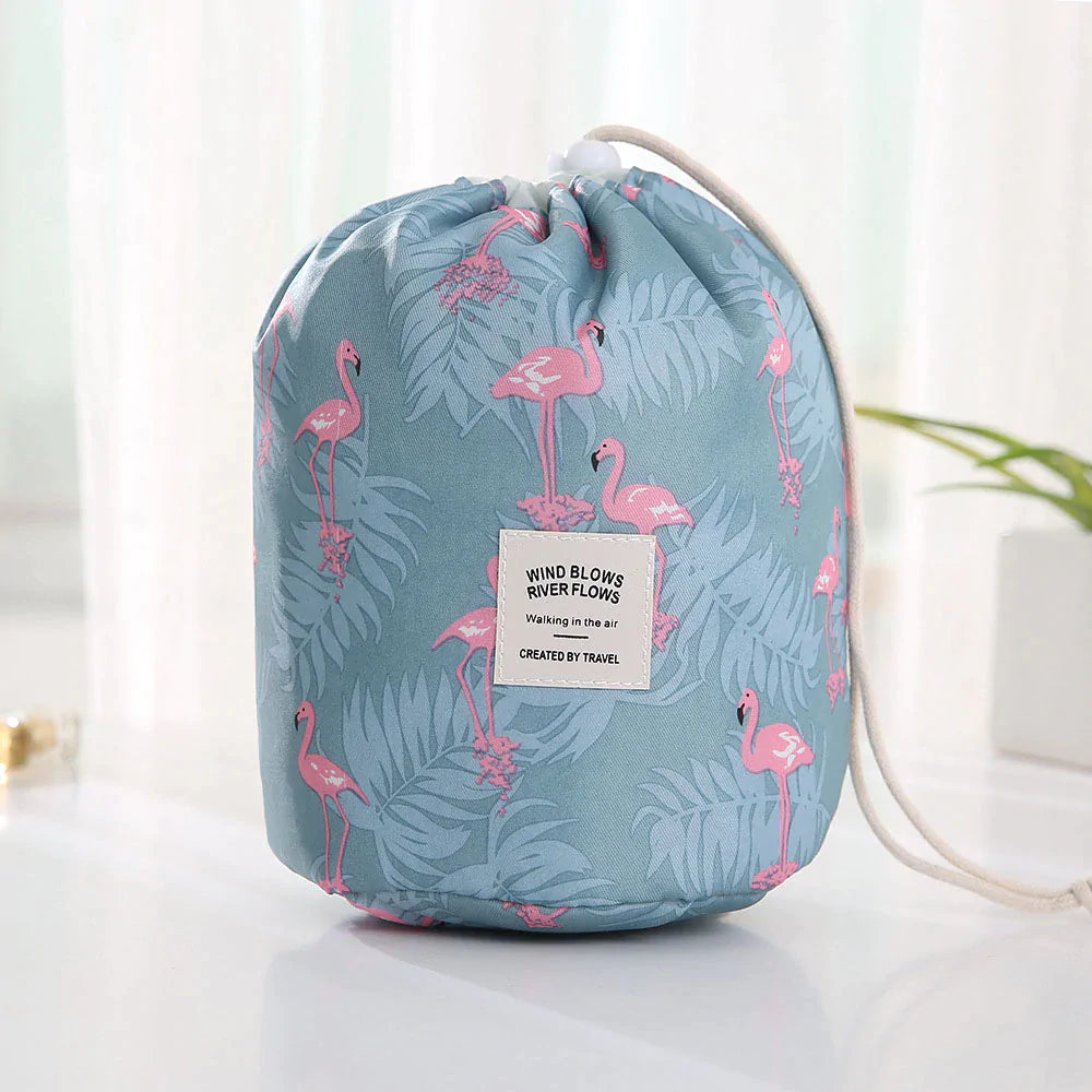 Blue drawstring bag with flamingo pattern on a white surface