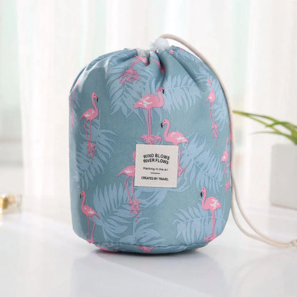 Blue drawstring bag with flamingo pattern on a white surface