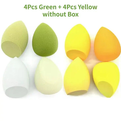 Set of 8 makeup sponges, 4 green and 4 yellow, without packaging on a white background.