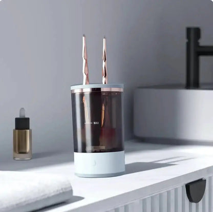 Clear cylindrical container with two metallic objects on a white surface