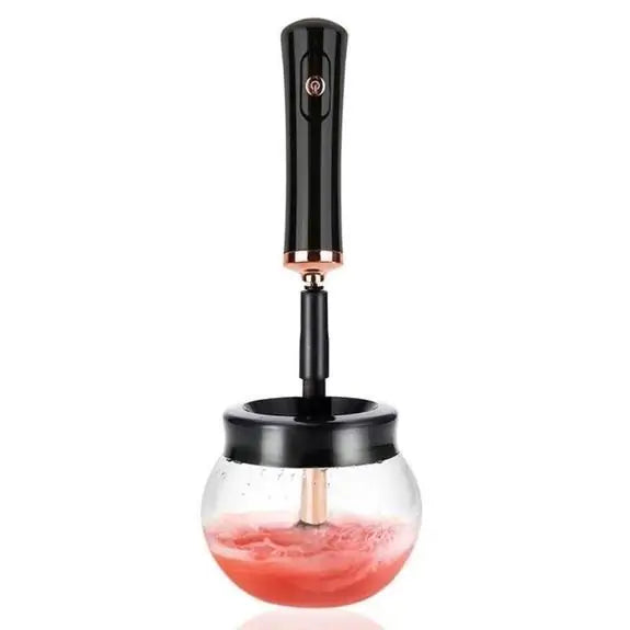Black handheld device with a glass container filled with red liquid on a white background
