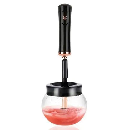 Black handheld device with a glass container filled with red liquid on a white background