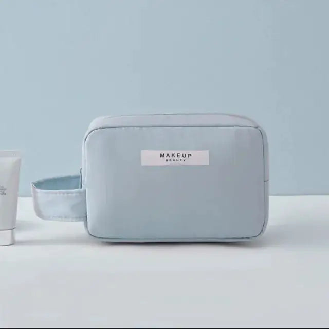 Light blue makeup bag with 'MAKEUP BEAUTY' label on a light gray background