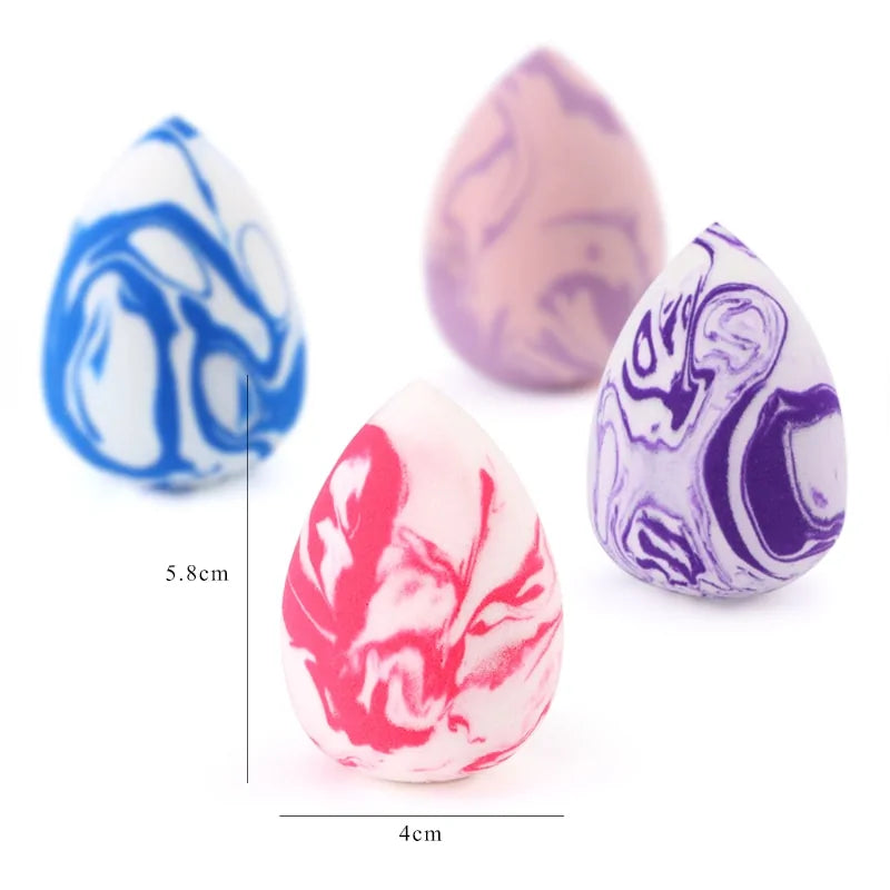 Four marbled egg-shaped objects with different color patterns on a white background.