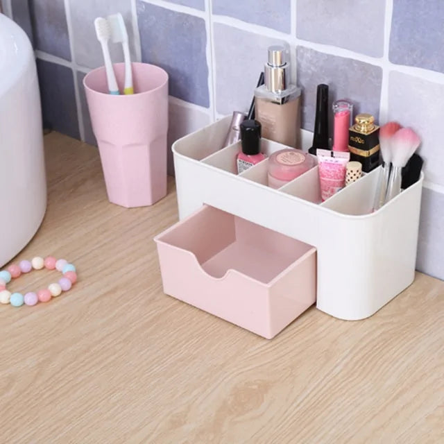 Bathroom counter with a white and pink storage caddy holding various items.