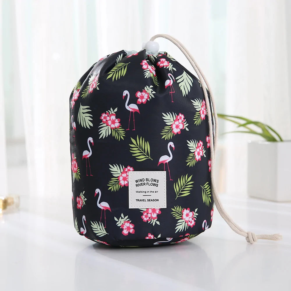 Drawstring bag with flamingo and floral pattern on a white surface