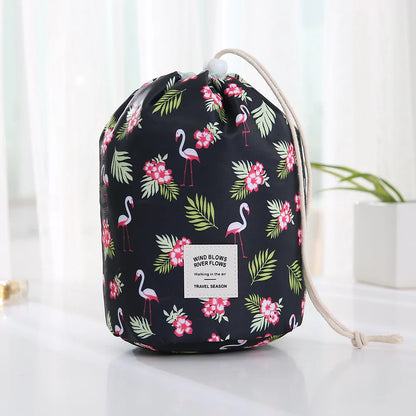 Drawstring bag with flamingo and floral pattern on a white surface