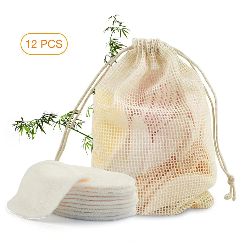 Drawstring bag with cotton pads and a branch of bamboo on a white background