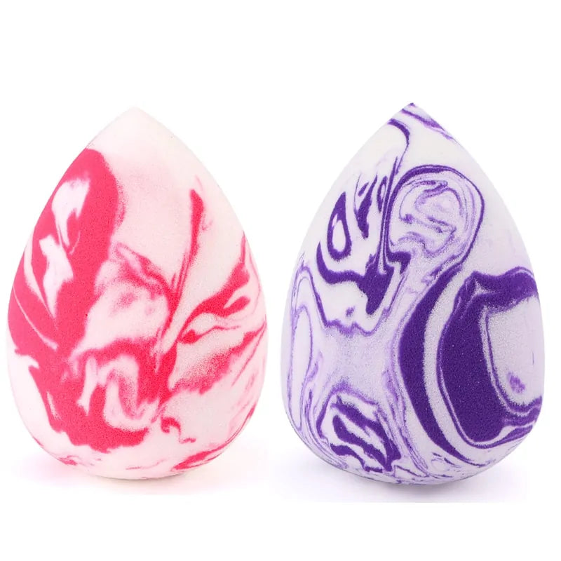 Two marbled eggs, one pink and white, one purple and white, on a white background.